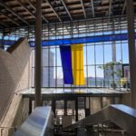 An image of the Ukrainian flag on display within a brightly lit Seattle City Hall.